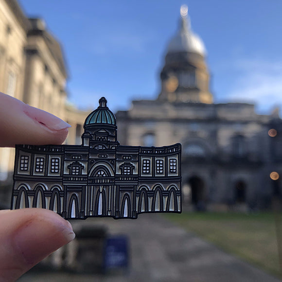 Old College Pin Badge held against Old College