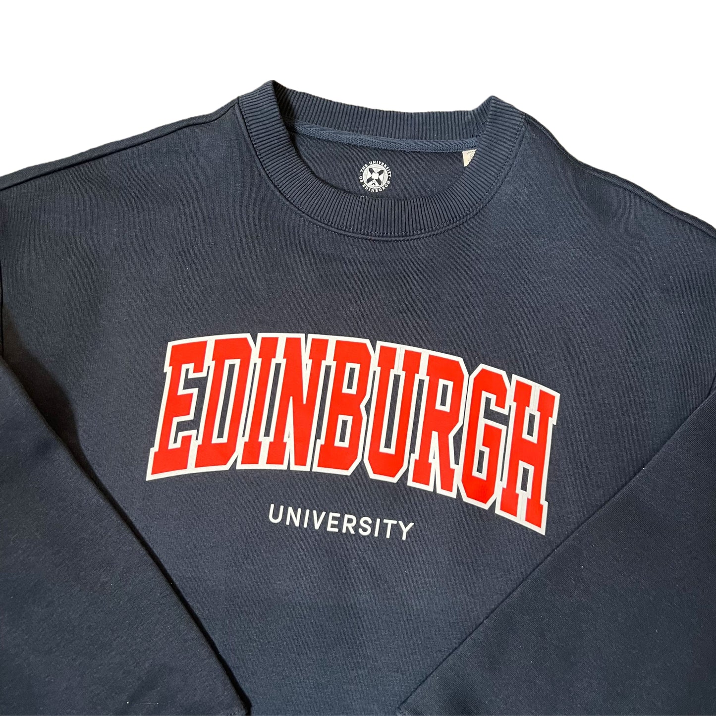 Close up of Navy sweatshirt with 'EDINBURGH UNIVERSITY' text in red and white