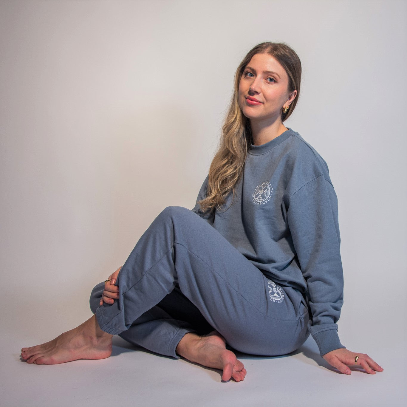 our model wears the embroidered sweatshirt and embroidered jogging bottoms in stone blue