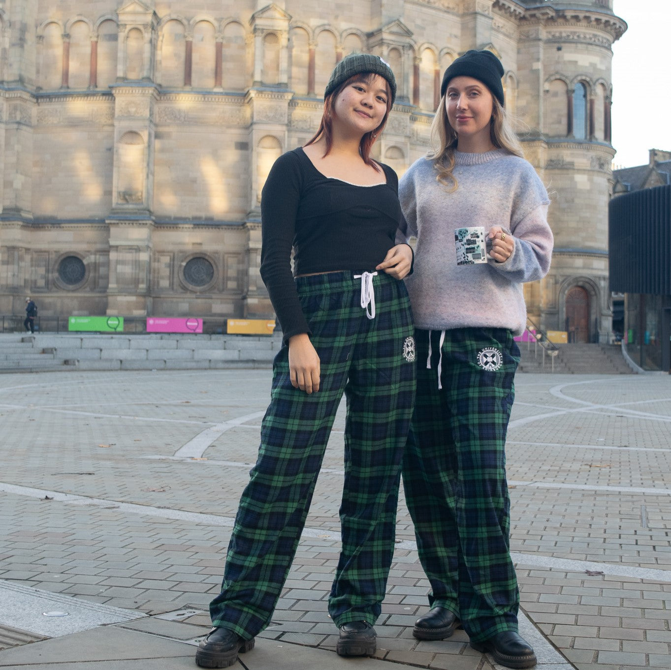two models wearing the navy/green tartan bottoms in front of mcewan hall